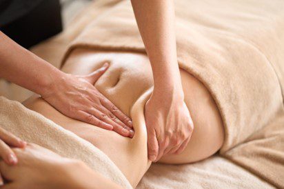 lymphatic drainage massage stomach services A women taking manual lymphatic drainage massage stomach
