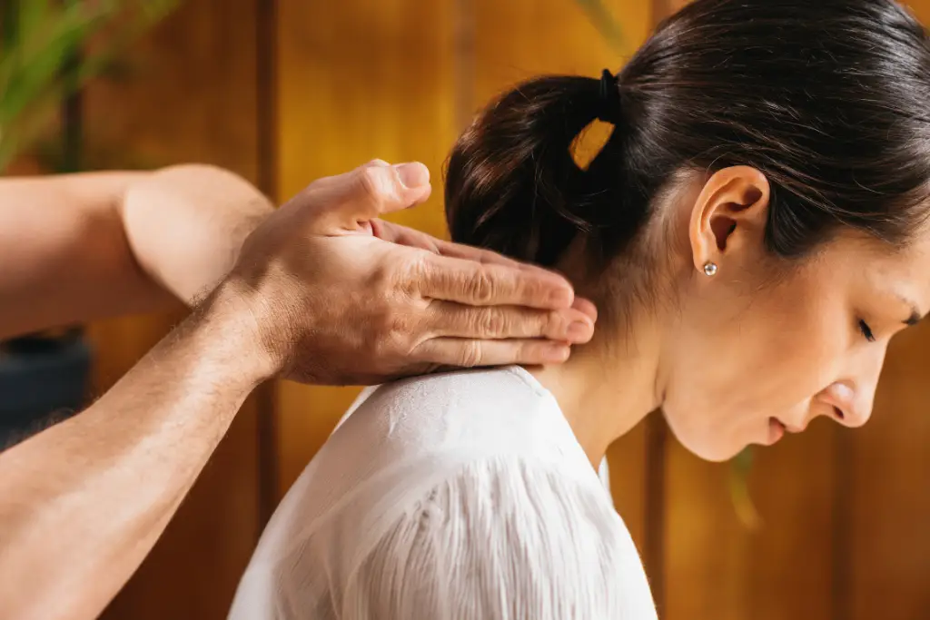 A woman receiving a neck massage.